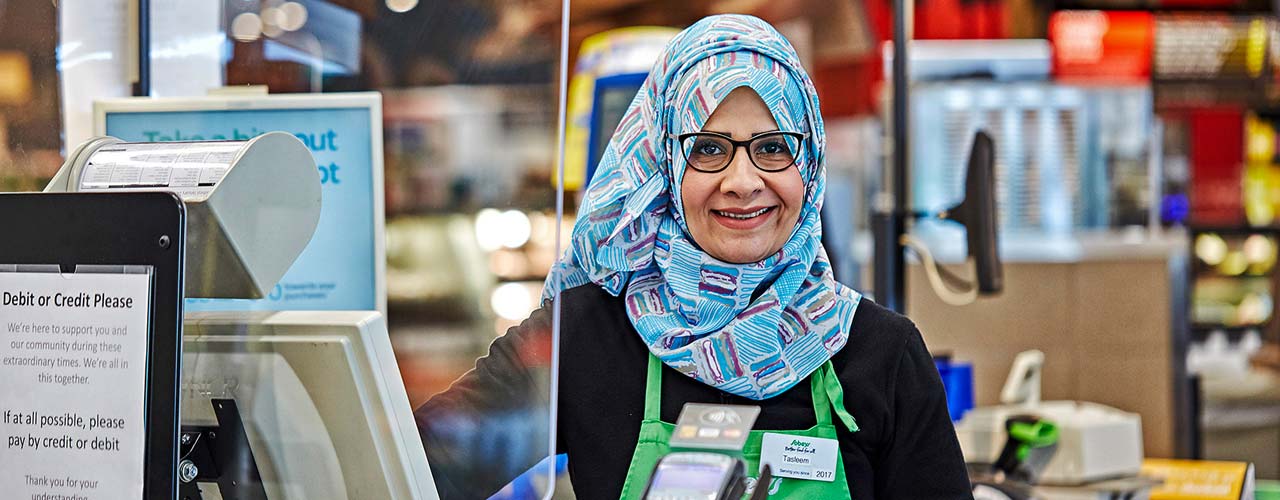 Sobeys cashier standing at her checkout.