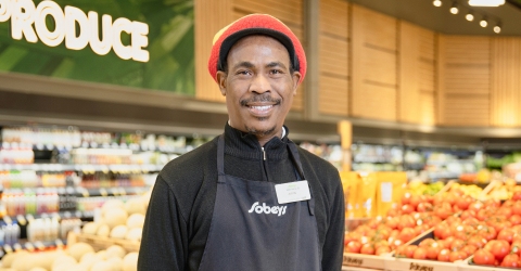 In this image, a man takes a picture with smile.