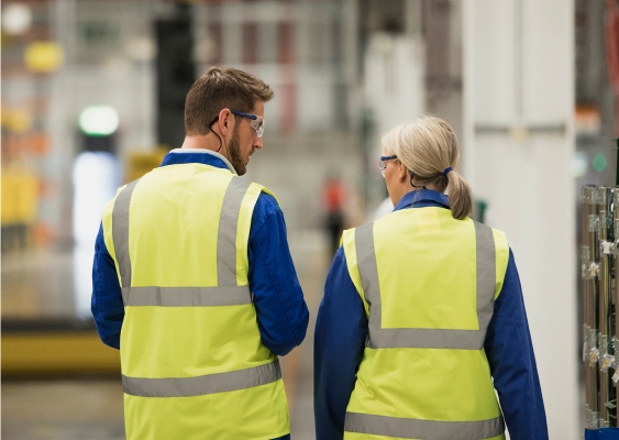 An image of safety leaders discussing something and walking together.